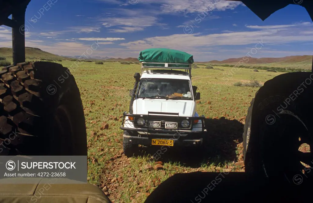Namibia, Kaokoveld, Damaraland, Palmwag Concession. Save The Rhino Trust 4WD vehicles patrol the plains for signs of the desert adapted rhino.