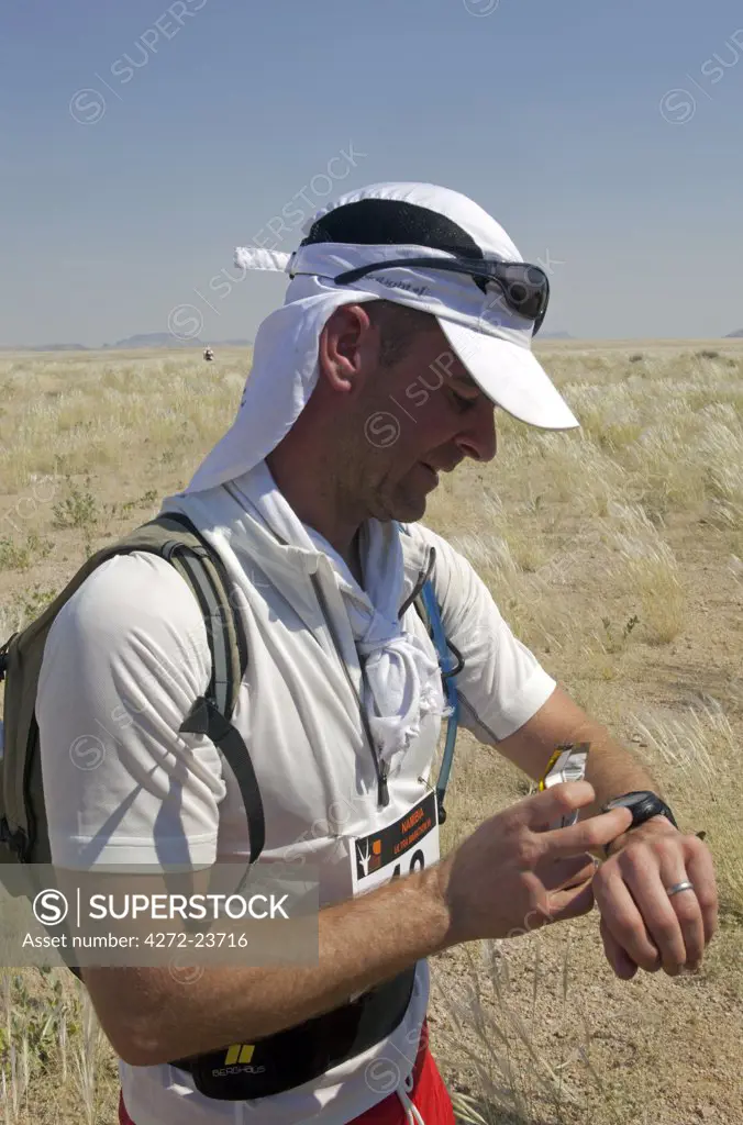 Namibia, Namib Desert, A runner competing in the Namibia Ultra Marathon from Brandberg Mountain to the Skeleton Coast (MR)