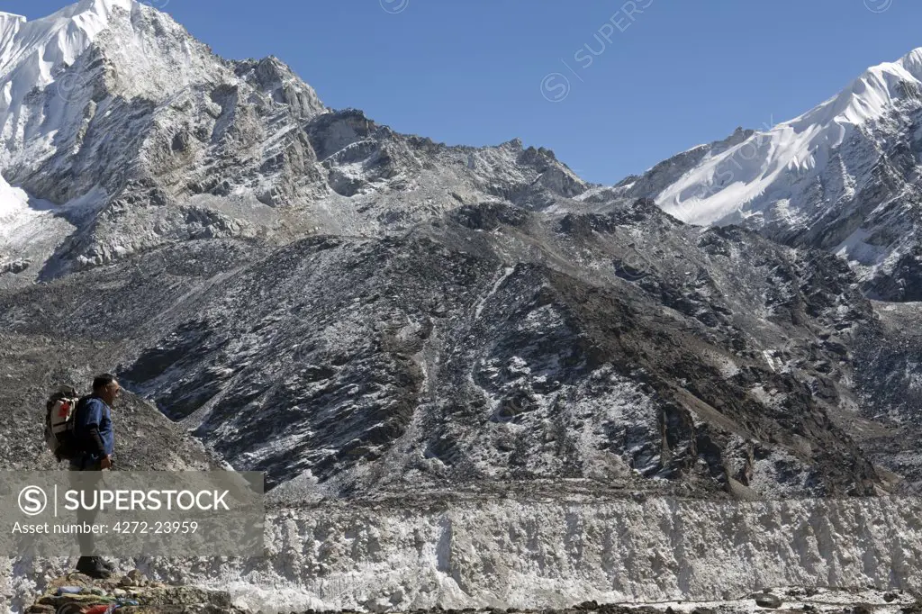 Nepal, Everest Region, Khumbu Valley. Trekker overlooking the Khumbu Glacier as it descends down the valley from Everest Base Camp