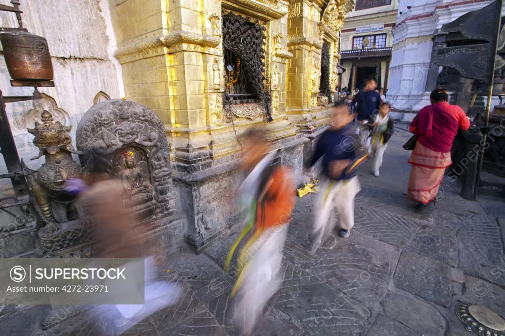 Nepal, Kathmandu, pilgrims spin prayer wheels at Swayambunath Temple (Monkey Temple) which overlooks the Kathmandu Valley