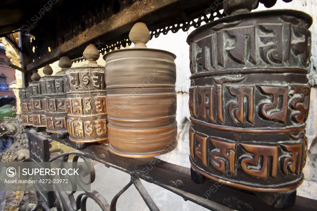 Nepal, Kathmandu, pilgrims spin prayer wheels at Swayambunath Temple (Monkey Temple) which overlooks the Kathmandu Valley