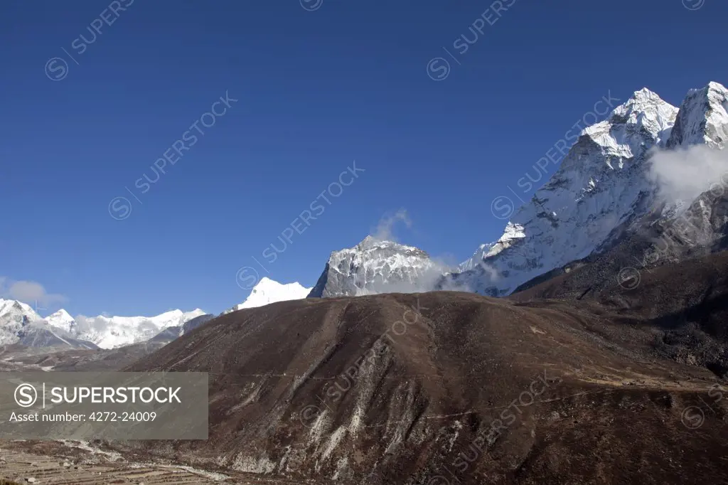 Nepal, Everest Region, Khumbu Valley. Looking past the dramatic ridge of Ama Dablam towards Island Peak and the south face of Lhotse.