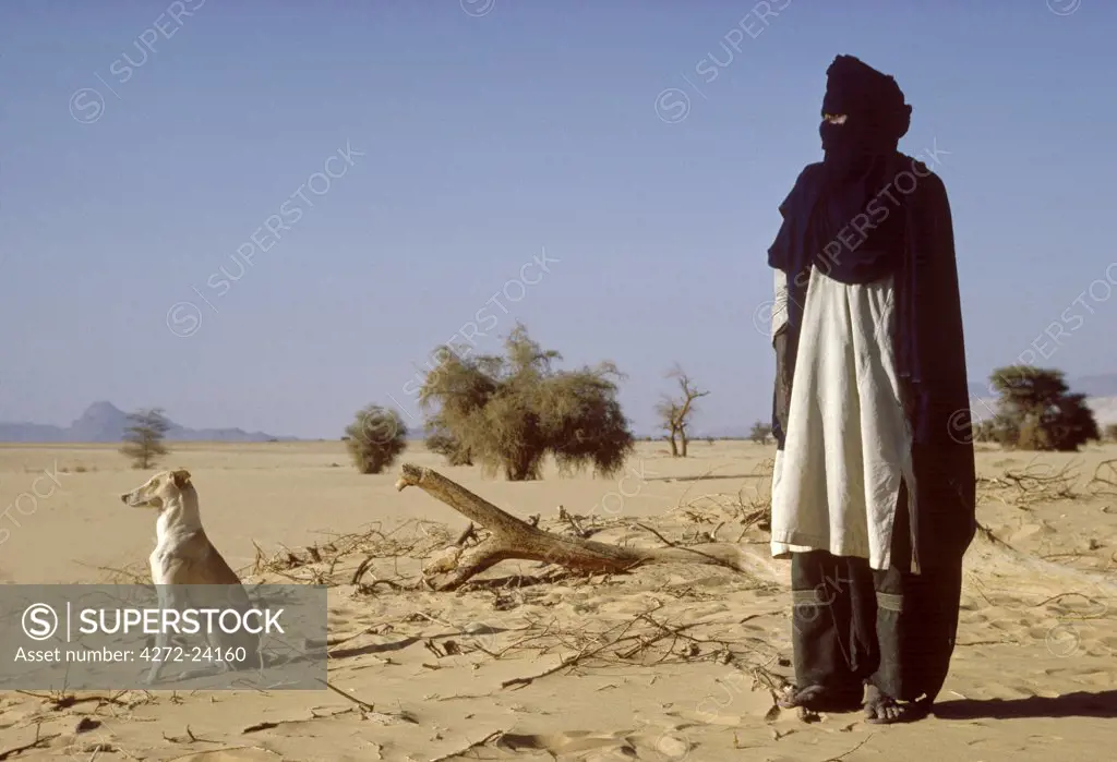 A Touareg tribesman and his hunting dog.,,