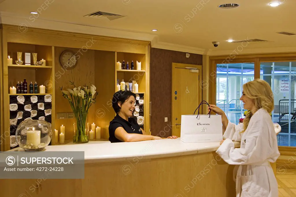 Northern Ireland, Fermanagh, Enniskillen.  A girl purchases some spa products at the Health Spa in the Killyhevlin Hotel