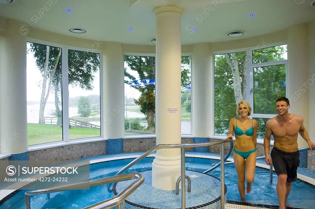 Northern Ireland, Fermanagh, Enniskillen. Couple walk out of the jacuzzi in the Health Spa at Killyhevlin Hotel. (MR)