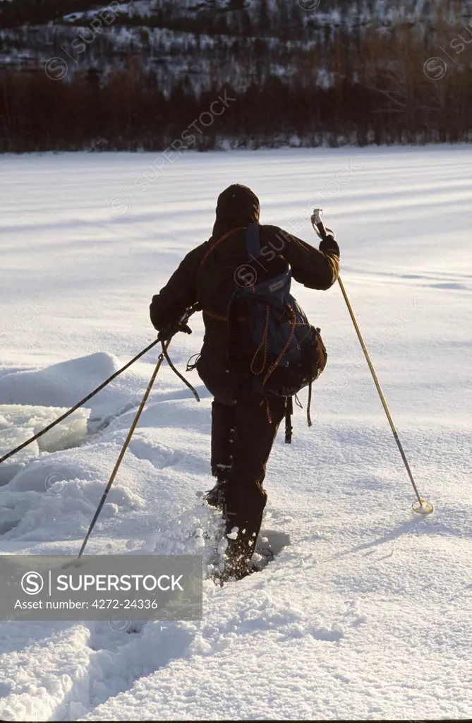 Snow shoes crossing snow covered frozen lake near Alta, Arctic Circle, Northern Norway. Worn by Dr. Sean Hudson