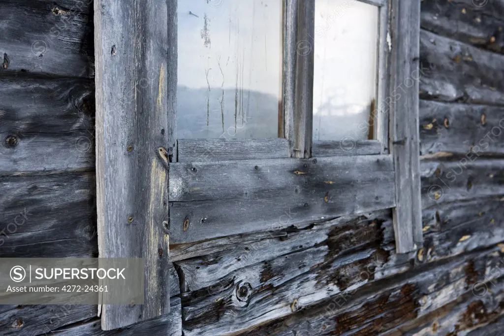 Norway, Troms, Lyngen Alps.  The weathered wooden boarding of a old farm building on the high plateau of the mountains.