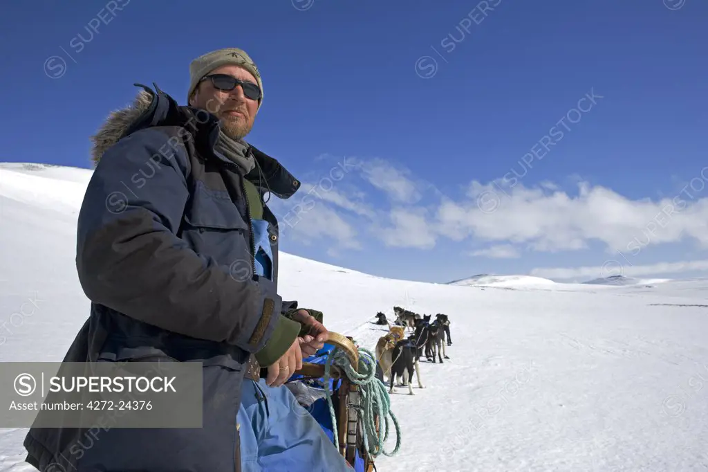 Norway, Troms, Lyngen Alps. Veteran Polar Explorer Norwegian Per Thore Hansen uses his dog sled team to cross the Lyngen Alps inland from Tromso in northern Norway. (MR).