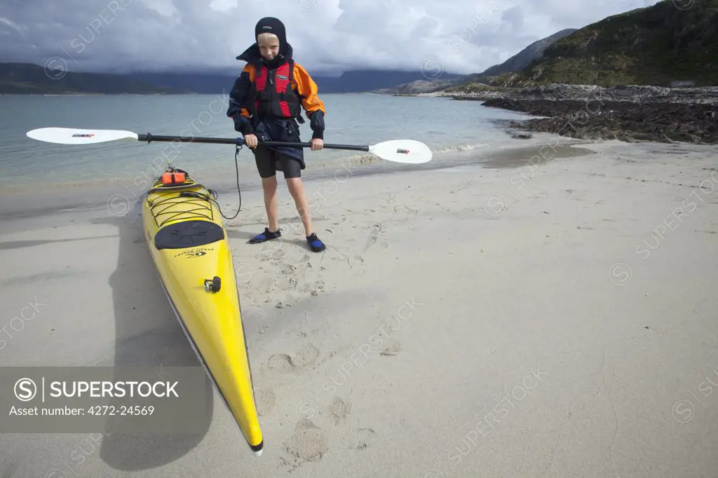 Norway, Tromso Region, Island of Somm¡r¡y.   A young boy has his first sea kayaking lesson. (MR)