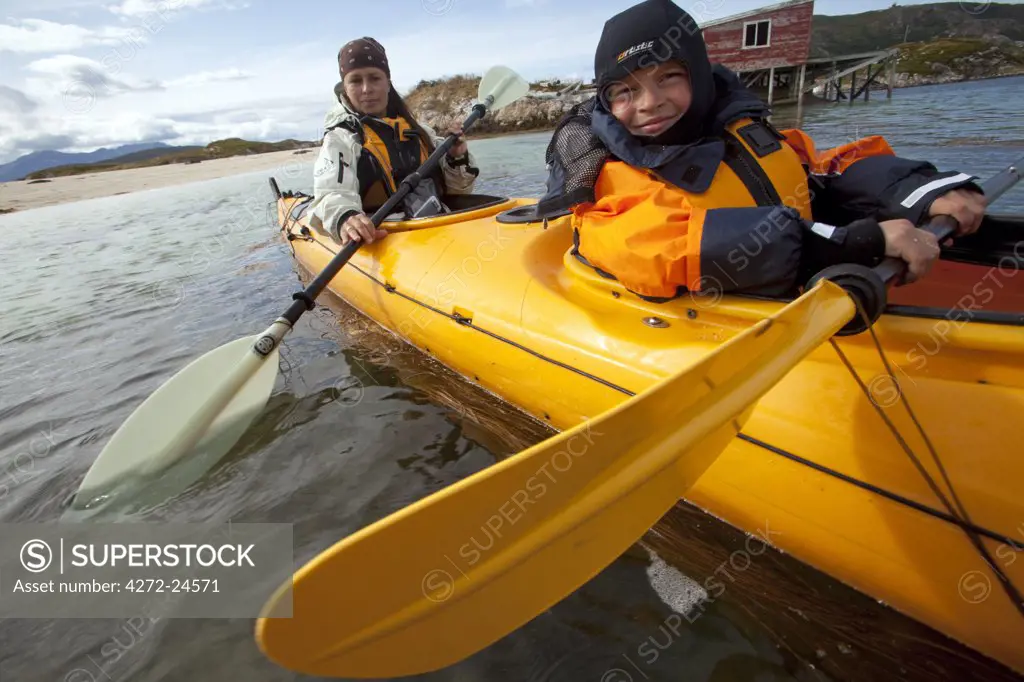 Norway, Tromso Region, Island of Somm¡r¡y. A norwegian family take to the calm water of the fjords to learn sea kayaking (MR)