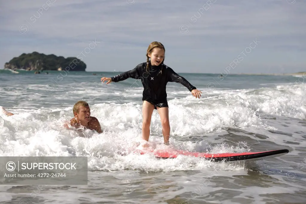 New Zealand, North Island, Coromandel Peninsula. Family surf lesson at Whangamata with Ricky Parker of Whangamata Surf School. (MR)