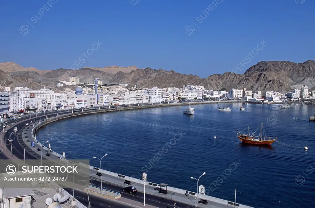 Muttrah Harbour is ringed by the Corniche, the buildings of the old city and the arid mountains behind