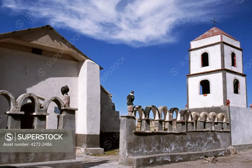 The main church at the small village of Tahua on the northern shore of the Salar de Uyuni, the world's largest salt flat.  Note the pair of carved stone condors on the gateposts.  In many Andean communities the religion is a blend of Catholicism with ancient animistic beliefs.