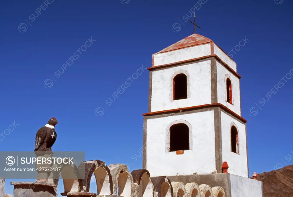 The main church at the small village of Tahua on the northern shore of the Salar de Uyuni, the world's largest salt flat.  Note the carved stone condor on the gatepost.  In many Andean communities the religion is a blend of Catholicism with ancient animistic beliefs.