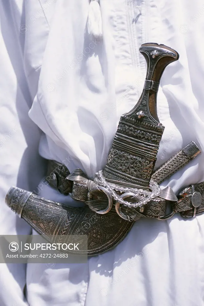 Omani men wear the traditional long white robes and ceremonial khanjar or curved dagger up on Al Jabal al Akhdar.