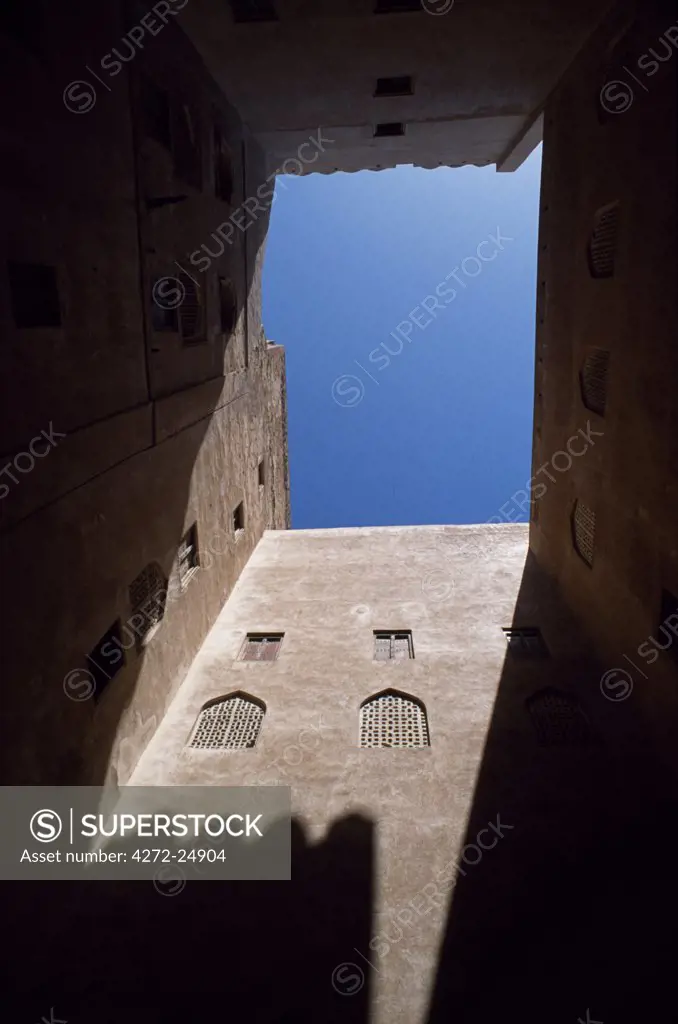 A view up the high walls enclosing the courtyard within Jabrin Castle.  A striking blend of defensive architecture and sophisticated artistry, the palace at Jabrin was built around 1670 AD at the height of the Ya'aruba dynasty as a seat of learning for students of Islamic jurisprudence, medicine and astrology.