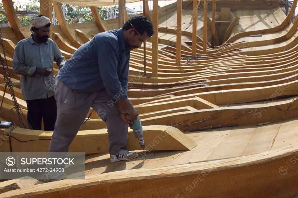 Boat builders constructing a large dhow in the boat yard at Sur