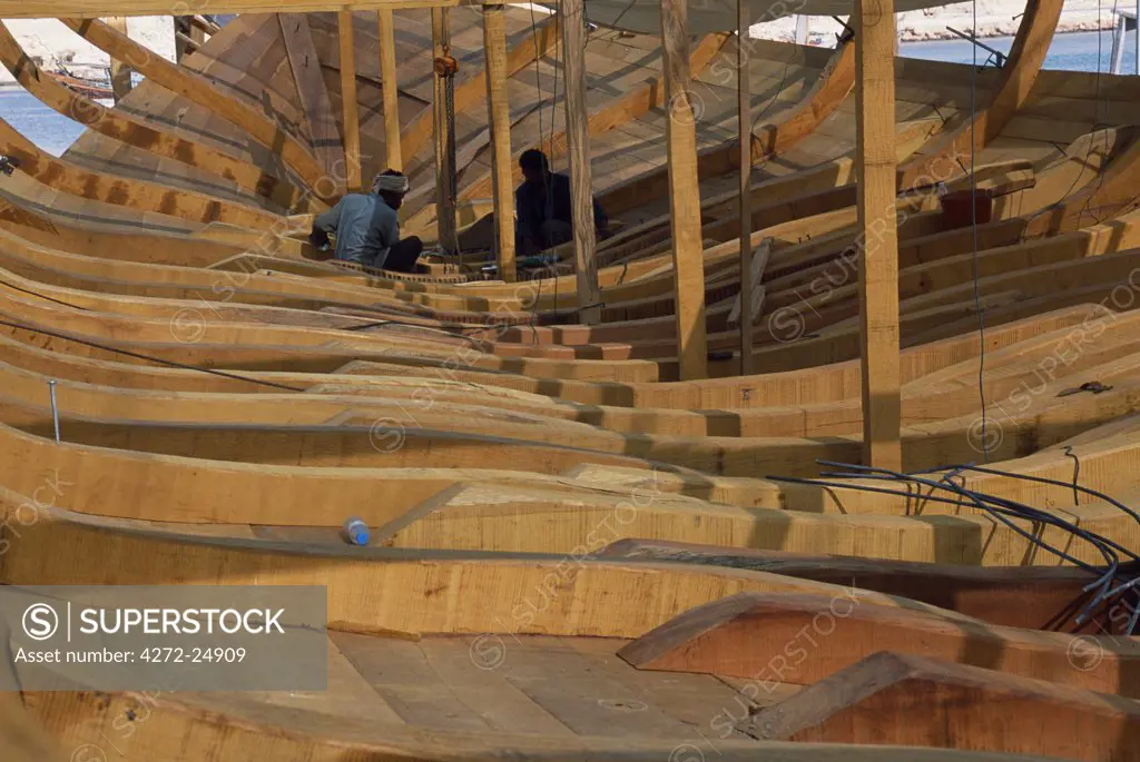 Boat builders constructing a large dhow in the boat yard at Sur