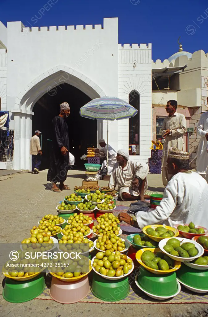 Oman, Muscat, Muttrah. Fruit sellers line the pavements outside Muttrah Souk.