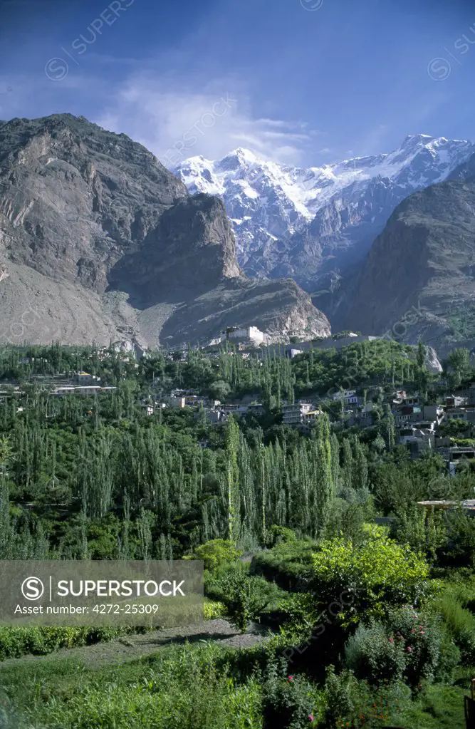 In the foreground are the lush orchards of the old town of Baltit and beyond to the north are the Karakorums with the peak of Ultar II visible