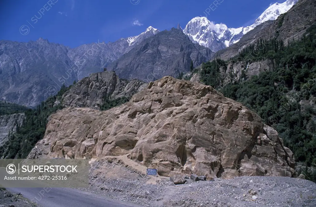 The Sacred Rock of Hunza, beside the Karakorum Highway near Karimibad, Northern Pakistan. Altit Fort just visible on the cliff in the distance.