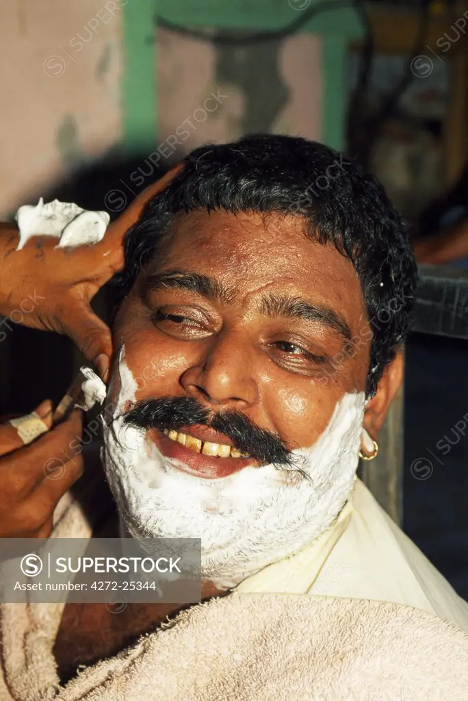 A close shave: most men in Pakistan visit a barber several times each week.