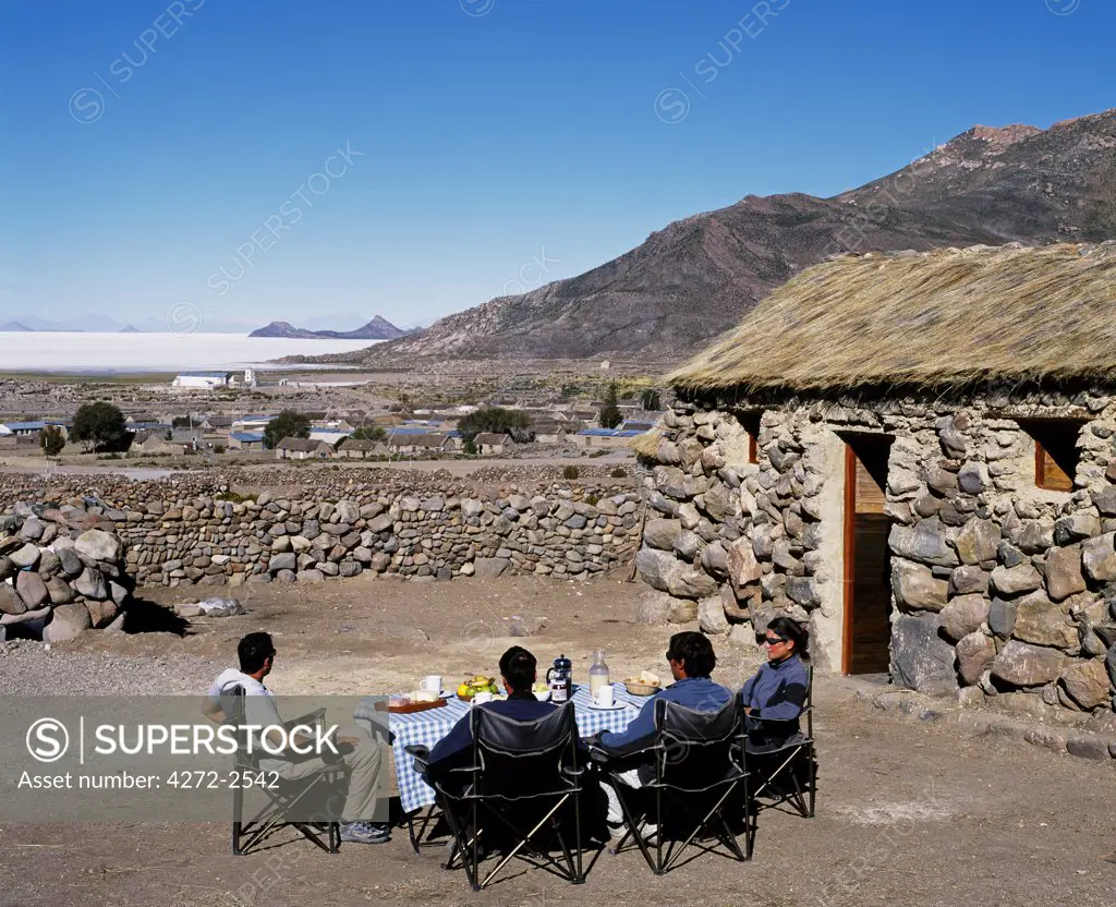 Tourists on Explora's Traversia of southern Bolivia enjoy breakfast in the sun at Explora's camp at the village of Tahua on the northern shore of the Salar de Uyuni, the largest salt flat in the world at over 12,000  square kilometres.