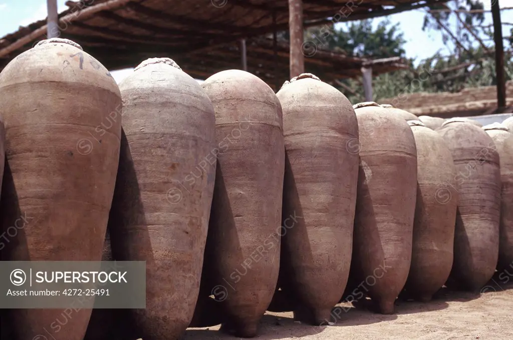Rows of pisqueras (earthen jars) in a bodega on the outskirts of Ica in Peru. The jars are used in the fermentation process of Pisco, Peru's national drink.