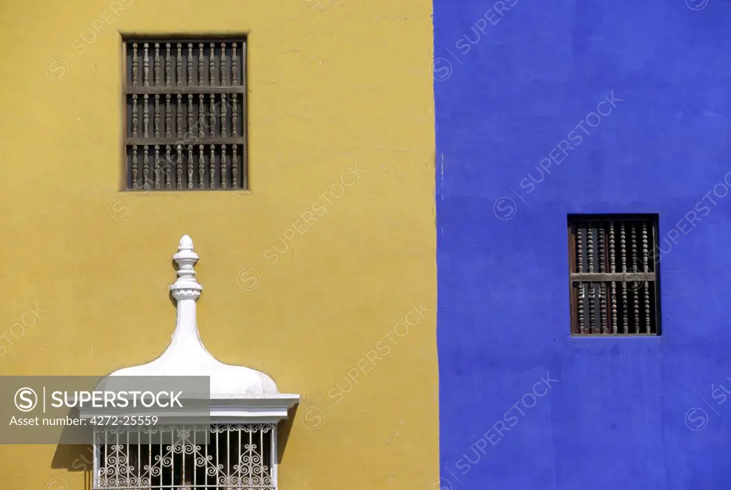 Wrought iron grillwork and pastel shades of the colonial mansions fronting the Plaza de Armas in Trujillo, Peru. The city in Peru's north, is one of the earliest colonial cities and was founded by Francisco Pizarro in 1535.
