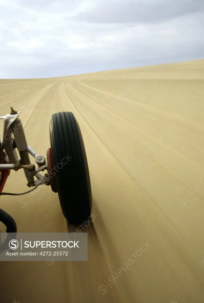 Speeding across desert sands in a dune buggy, near the oasis village of Huacachina, southern Peru
