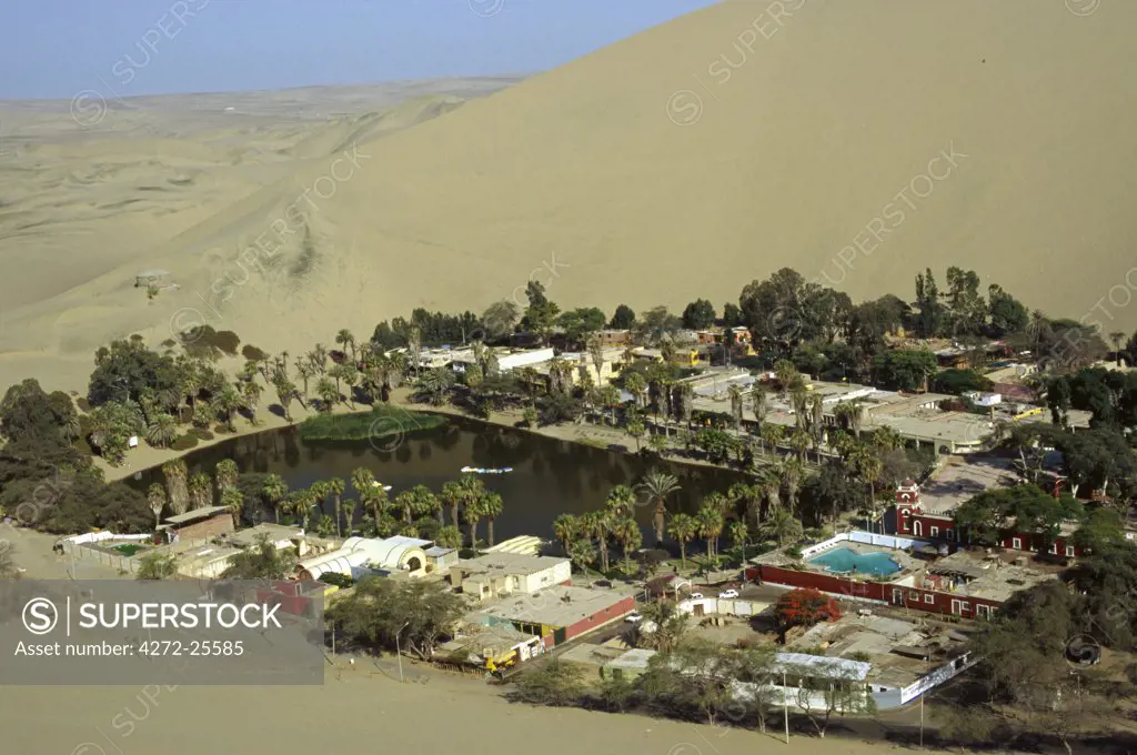 Hotels and restaurants ring the desert lagoon of Huacachina, a popular tourist spot, near Ica in southern Peru.