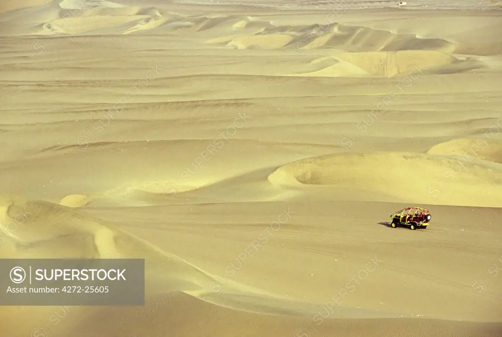 A dune buggy heads out amidst the sand dunes, near Huacachina in southern Peru.