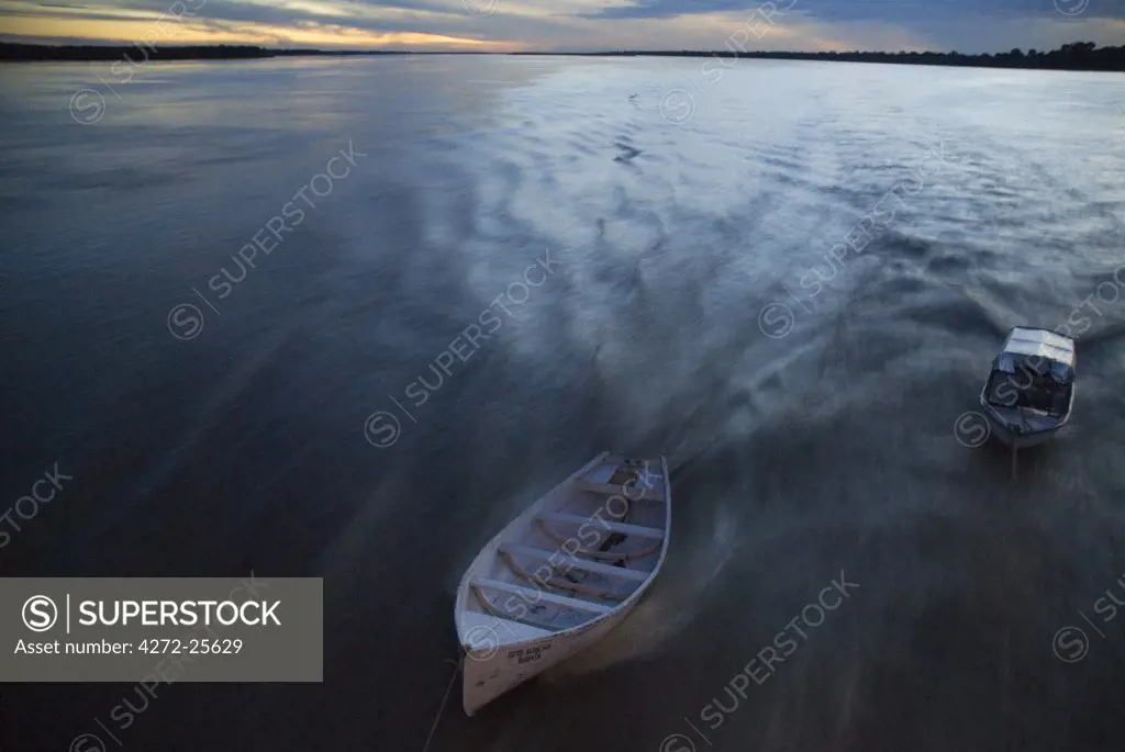 Peru, Amazon, Amazon River. Ancillary baots being towed by the Ayapua Riverboat, Amazon River.