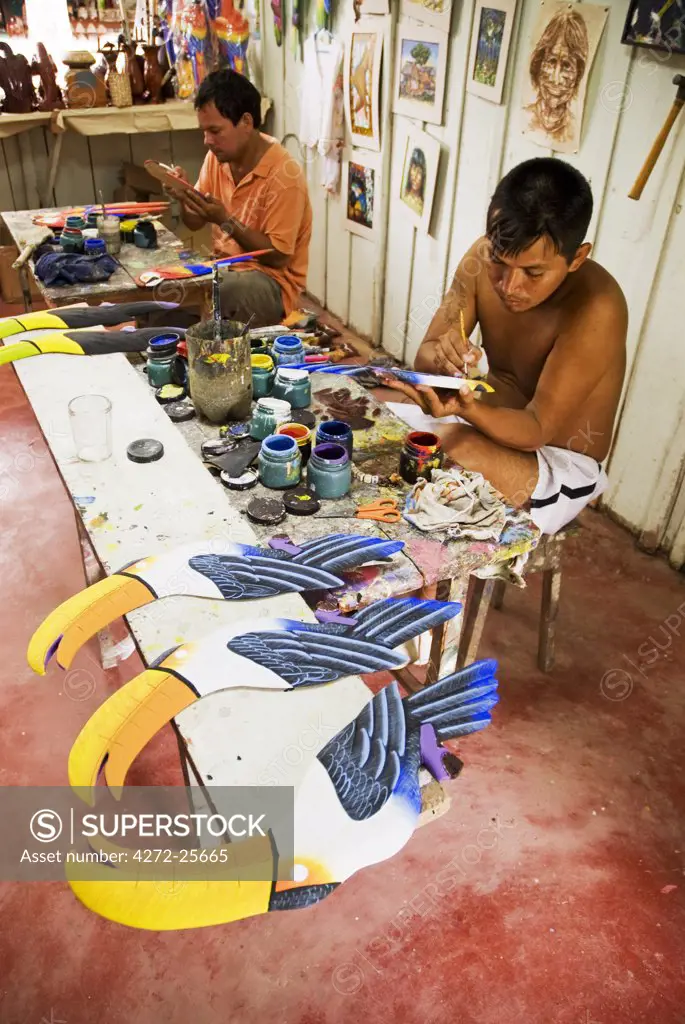 Peru, Amazon, Amazon River. Artist's workshop in Iquitos - carving tropical birds out of balsa wood.