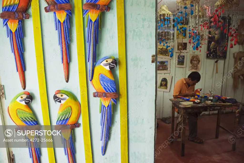 Peru, Amazon, Amazon River. Artist's workshop in Iquitos - carving tropical birds out of balsa wood.