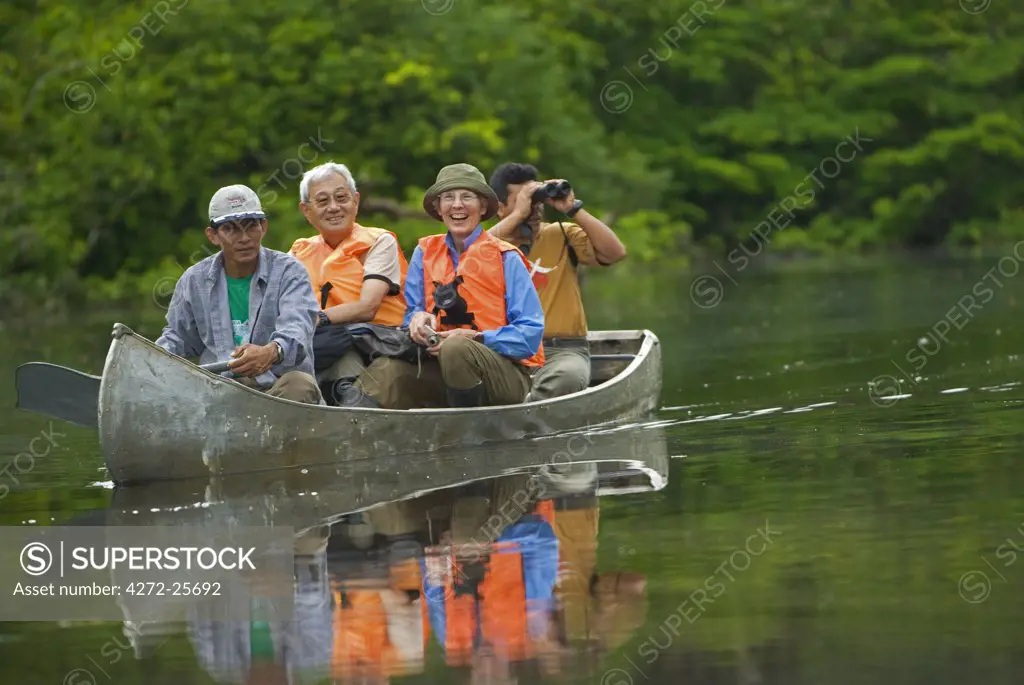 Peru, Amazon, Amazon River. Earthwatch Volunteers and scientist travelling on the Yavari River to the start of a land Transect to observe & record fauna & flora, Lago Preto, Amazon, Peru. (MR).