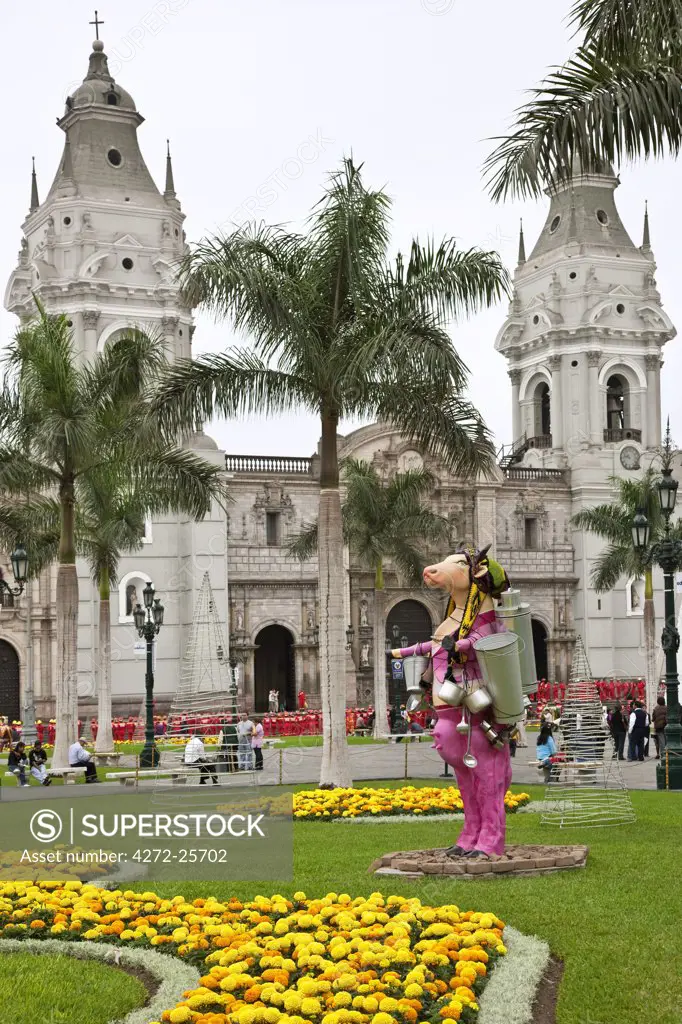 Peru. Plaza Mayor with Lima Cathedral. Attractive modern statues decorate the gardens.