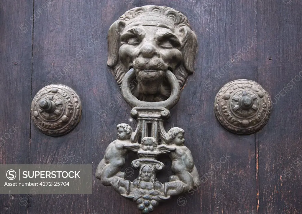 Peru. A knocker decorates the wooden doors of Lima Cathedral. Built 1555 but almost destroyed by 1746's earthquake