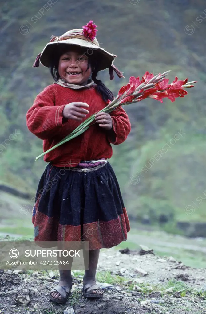 A Runa girl proudly shows off a gladioli. With the drab colours of the landscape as a background, the natives love of bright colours and particularly flowers is especially clear.