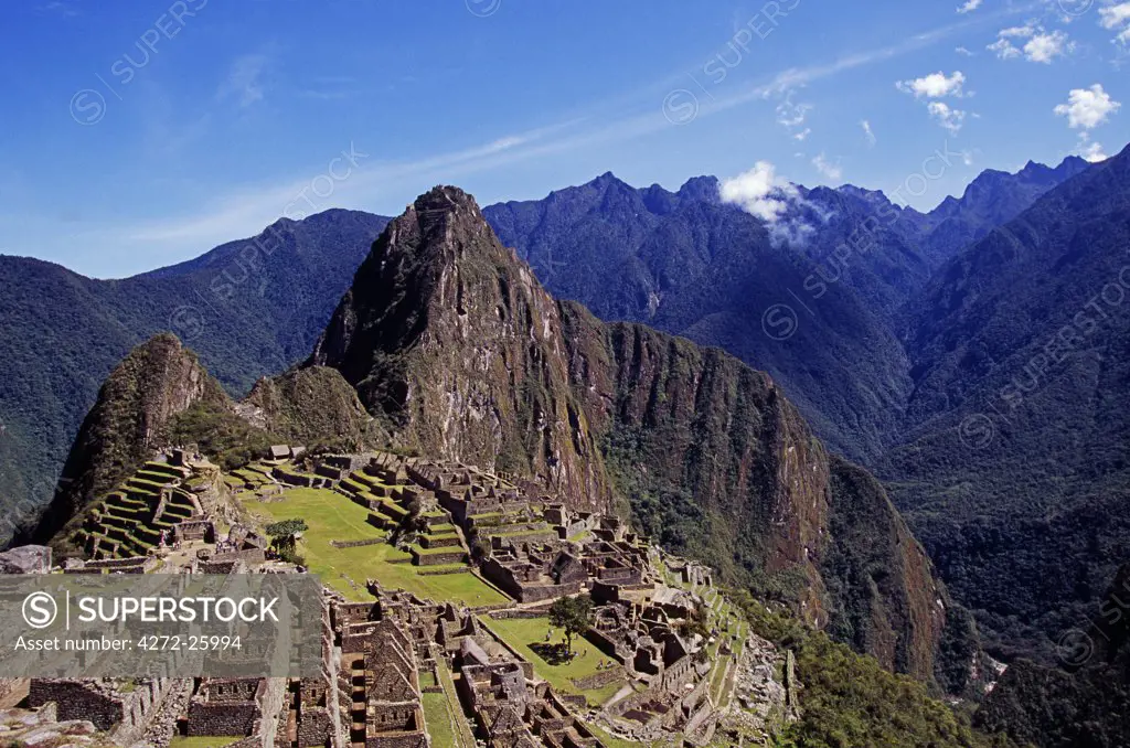 Peru, Urubamba Valley, Machu Picchu. View of the ancient Inca citadel of Machu Picchu with the prominent peak of Huayna Picchu behind. Built by the Inca Emperor Pachacuti in the fifteenth century AD, Machu Picchu became an important agricultural centre as well as a stronghold and centre of sacred temples.