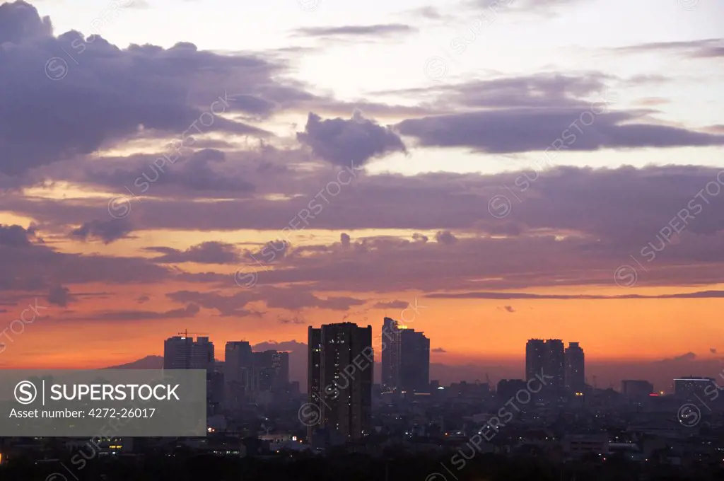 Philippines, Luzon, Manila. Makati business district city skyline at sunset.