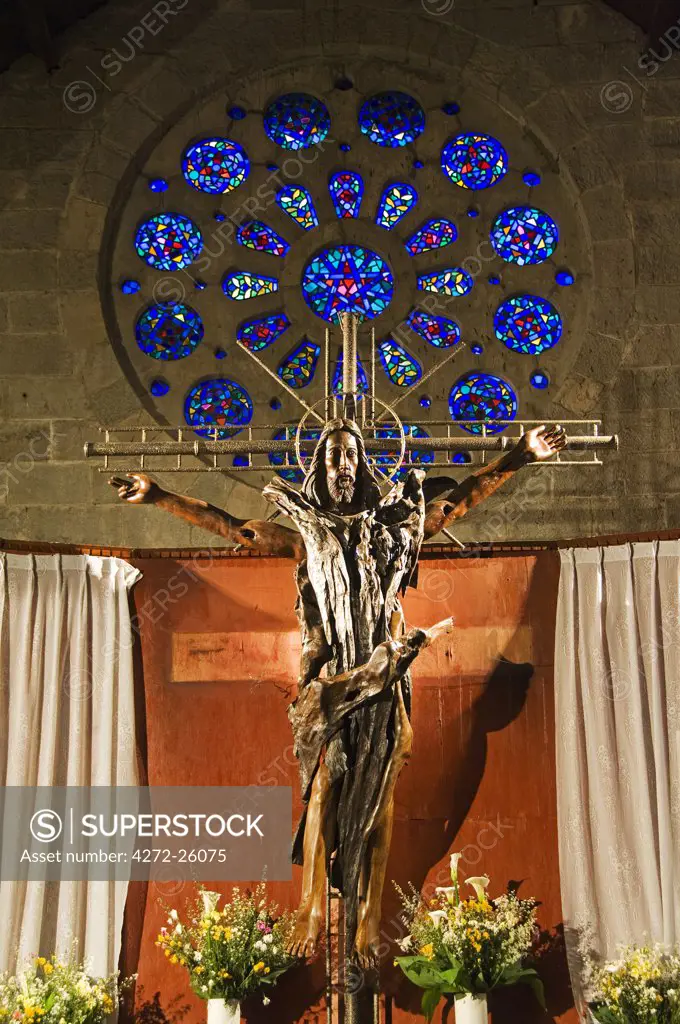 Philippines, Luzon Island, The Cordillera Mountains, Mountain Province, Sagada. St Mary's Episcopal Church - wooden sculptured crucifix of Christ.