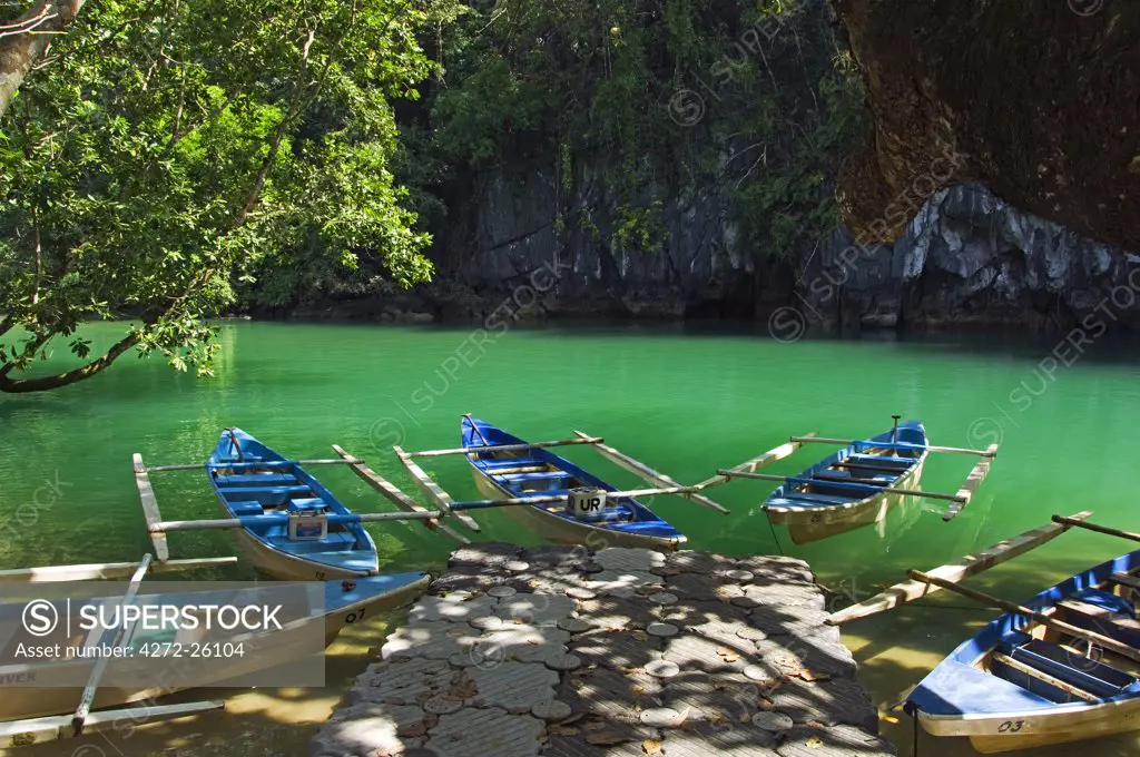 Philippines, Palawan, Sabang Town. Subterranean River National Park - paddle boats at entrance to Riverine Cave - longest navigable river traversed tunnel in the world.
