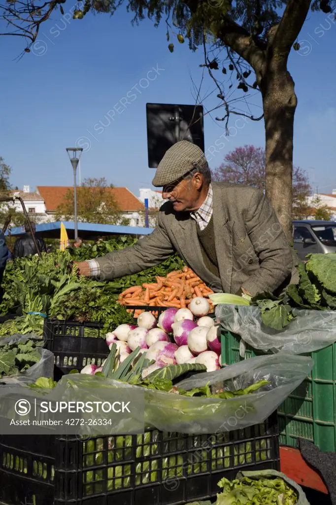 Portugal, Alentejo, Estremoz. A portuguese farmer sells vegetables at the saturday fair in the town of Estremoz in the Alentejo region of Portugal.