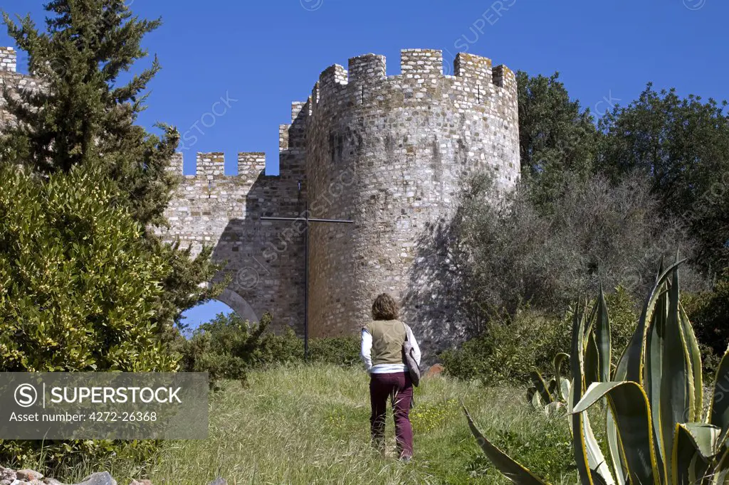 A young tourist takes a path up to the castle in the marble town of Vila Vicosa in the Alentejo region of Portugal. The castle was built by Dom Dinis at the end of the 13th century.