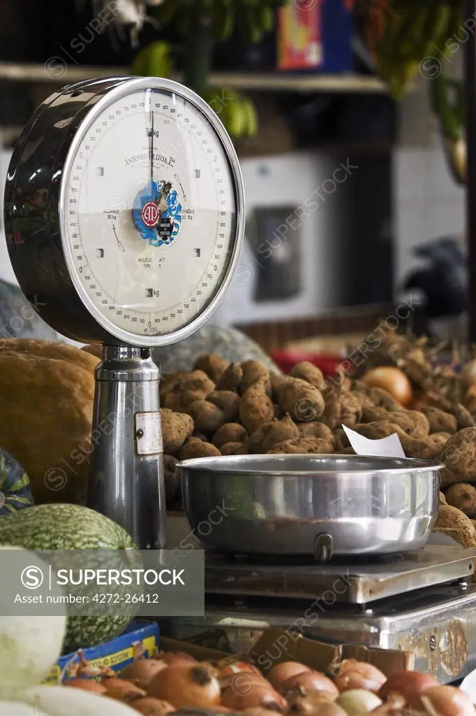 Portugal, Ilha de Madeira, Funchal, Santa Luzia. Weighing scales and vegetable display in the vegetable market in Santa Luzia.