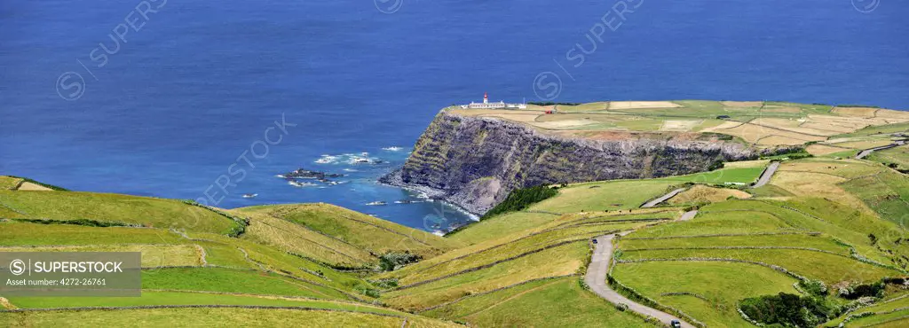Albarnaz lighthouse and coastline in the middle of the Atlantic Ocean. Flores, Azores islands, Portugal