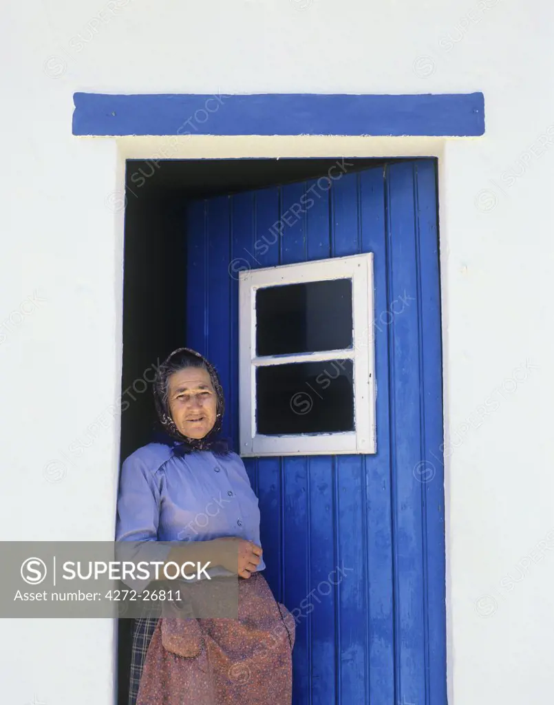 An old woman in front of her traditional house, Ribatejo, Portugal