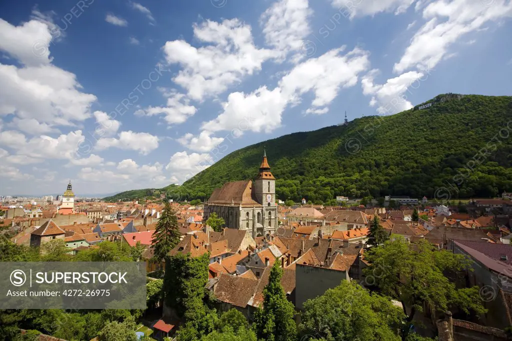 Romania, Transylvania, Brasov. Rooftops of the old centre of Brasov, surrounded by woodlands.