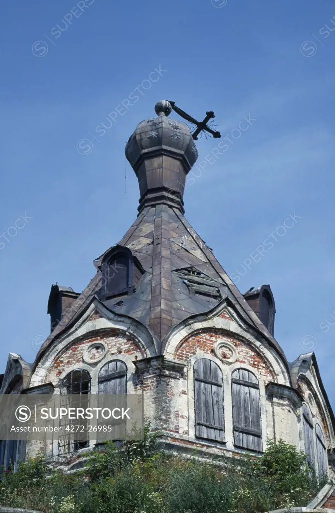 Damaged crucifix atop Russian orthodox church.